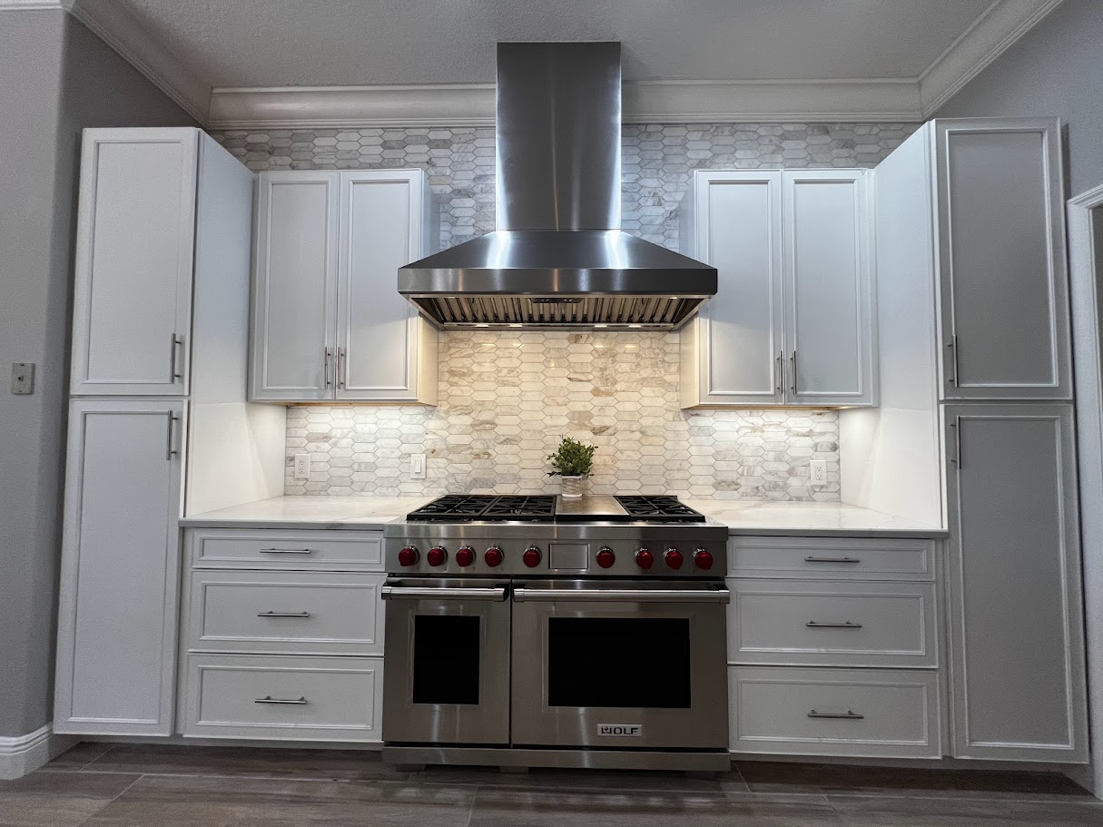 Kitchen with Wolf range and hexagonal marble backsplash tile